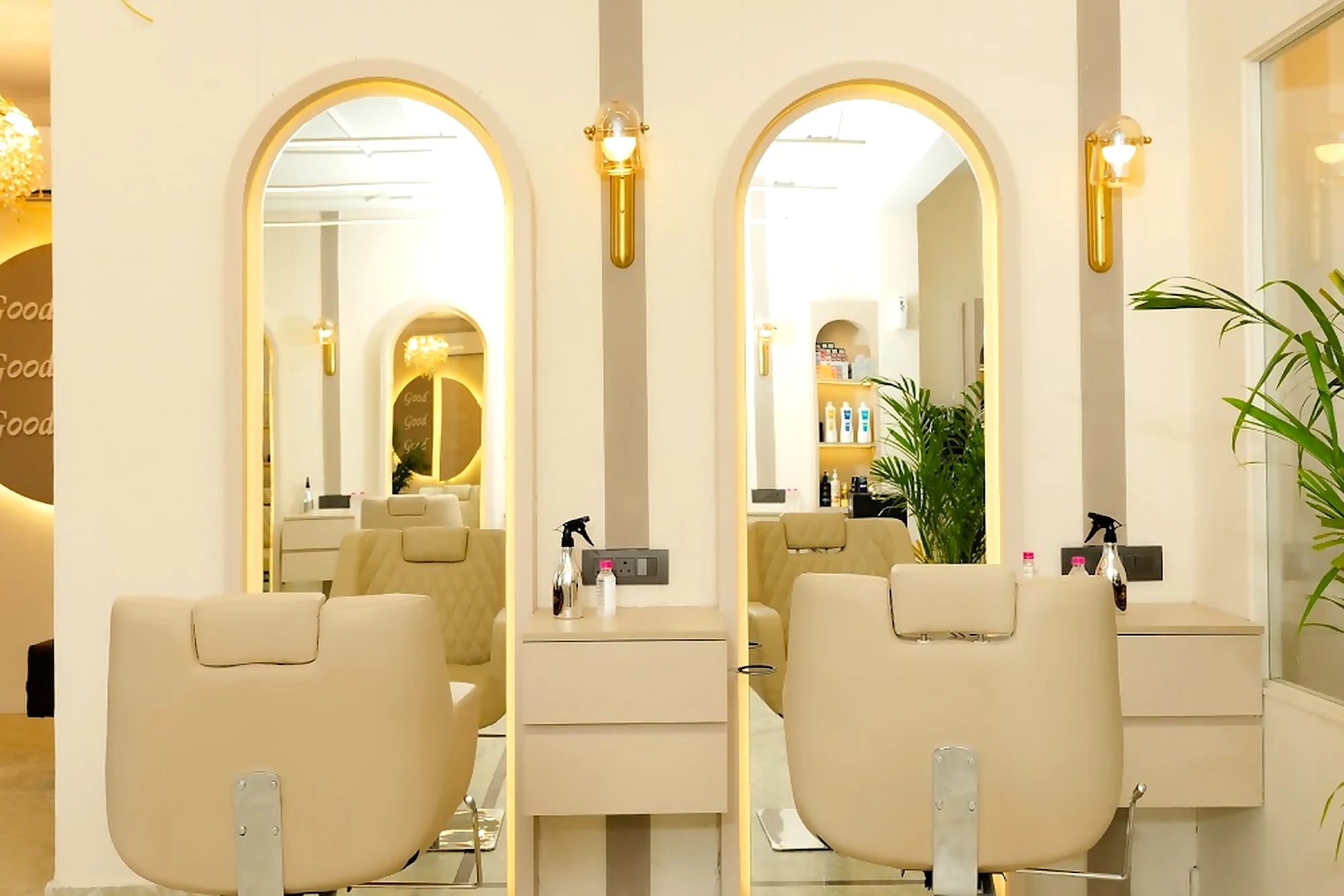 Styling stations with gold arch mirrors and cream chairs