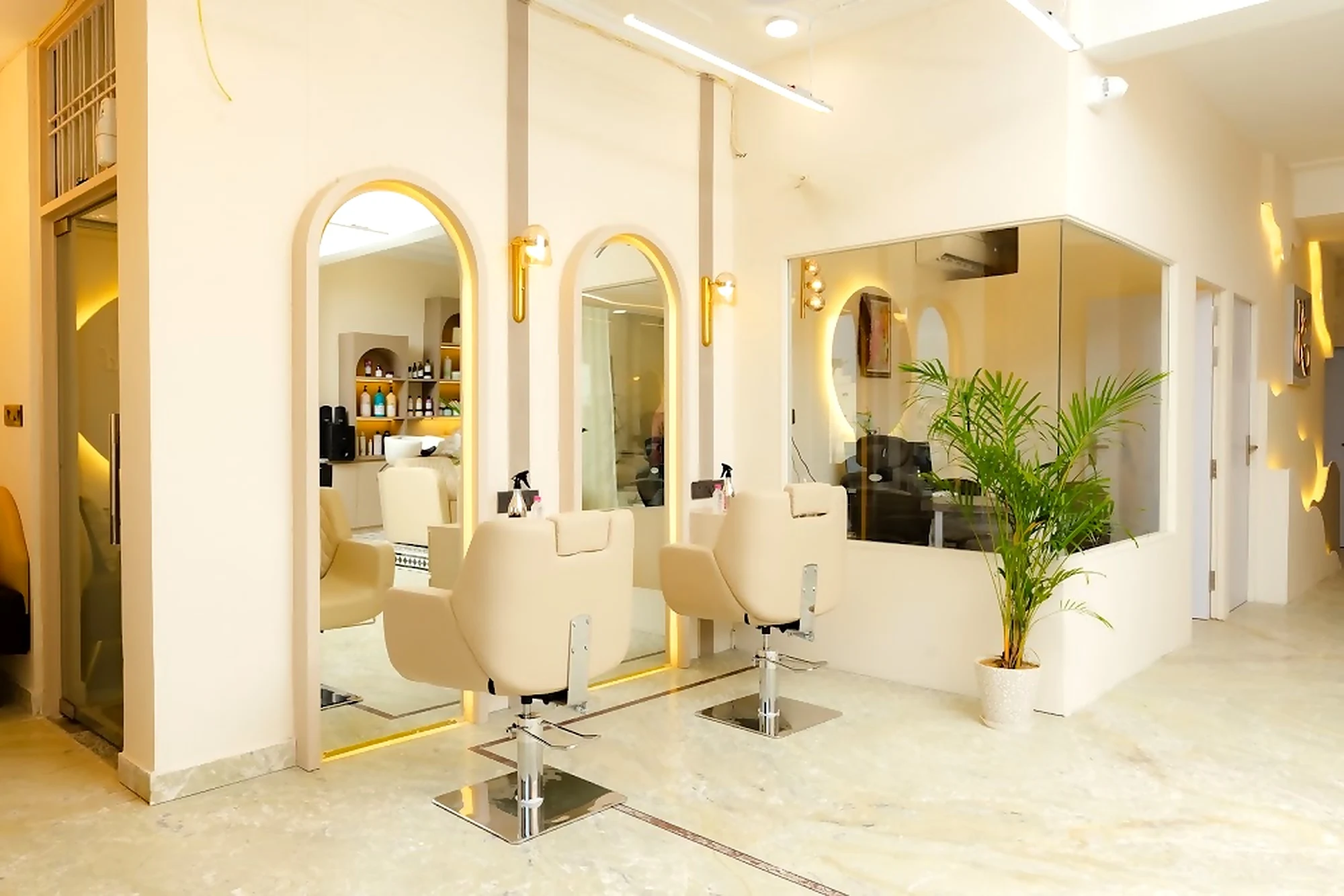 Styling stations with backlit gold arch mirrors
